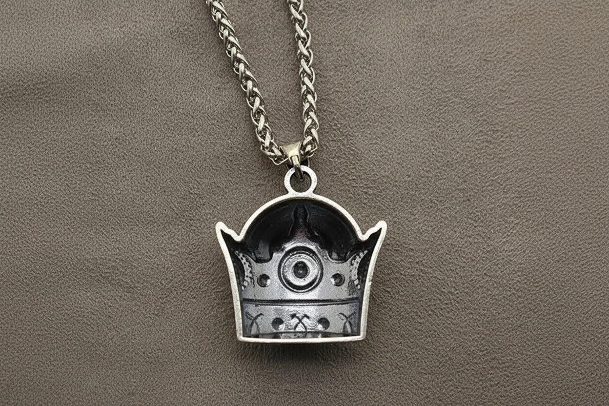 Silver pendant necklace on a textured gray background