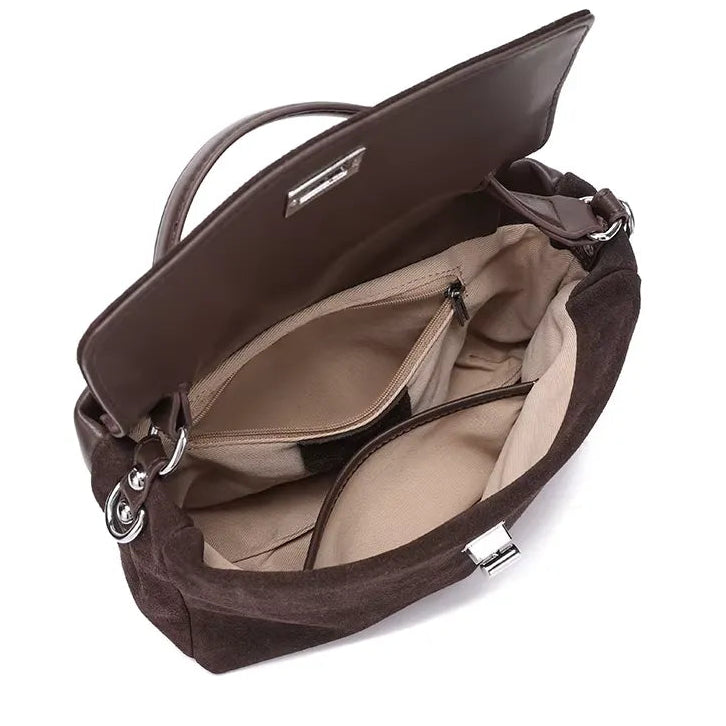 Brown handbag with open compartments on a white background, featuring icons of items it can accommodate.