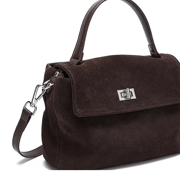Brown handbag with adjustable and detachable shoulder strap on a white background