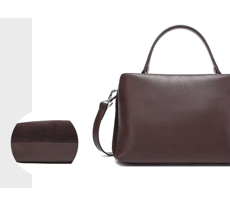 Brown leather handbag with a close-up of the back on a white background
