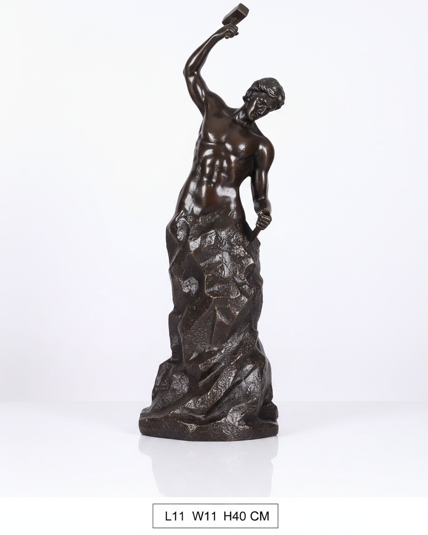 Bronze statue of a figure holding a torch on a wooden surface with a gray background