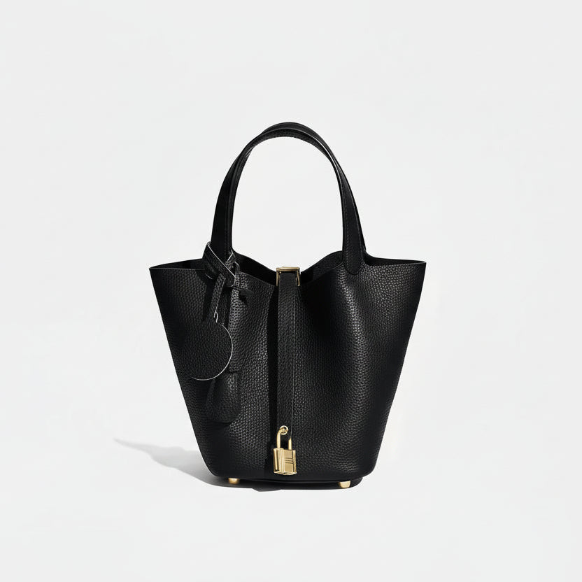 Black handbag with gold accents on a white background