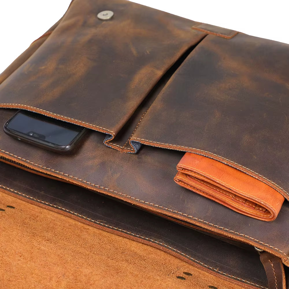 Brown leather bag with a phone inside on a white background