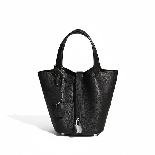 Black leather handbag with a lock on a white background