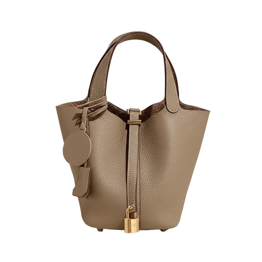 Beige handbag with gold accents on a light gray background