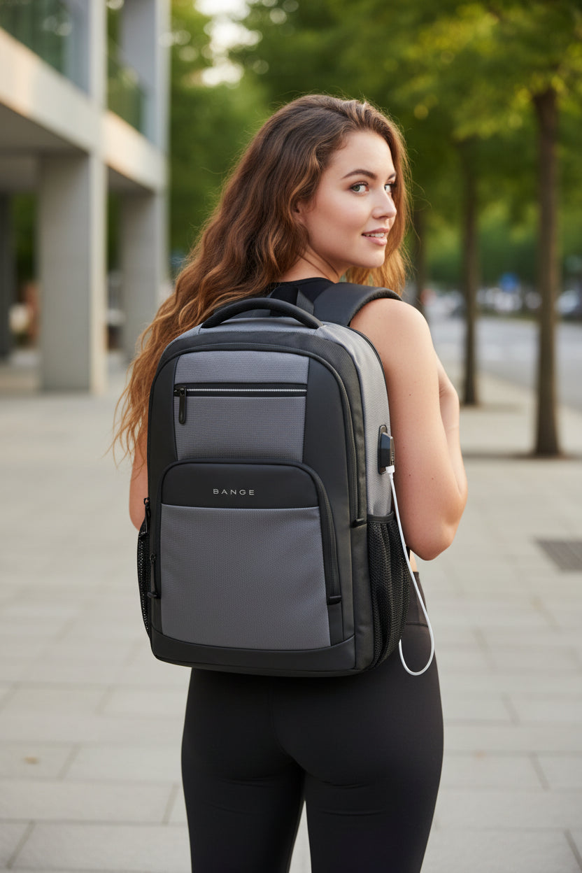 Gray backpack with USB port and smartphone showing charging icon on a white background