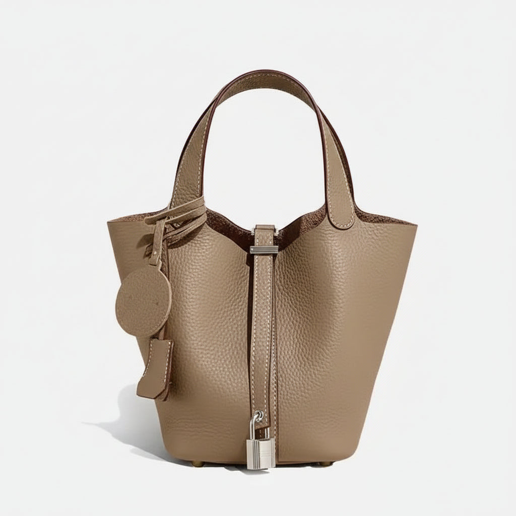 Beige handbag with silver accents on a white background
