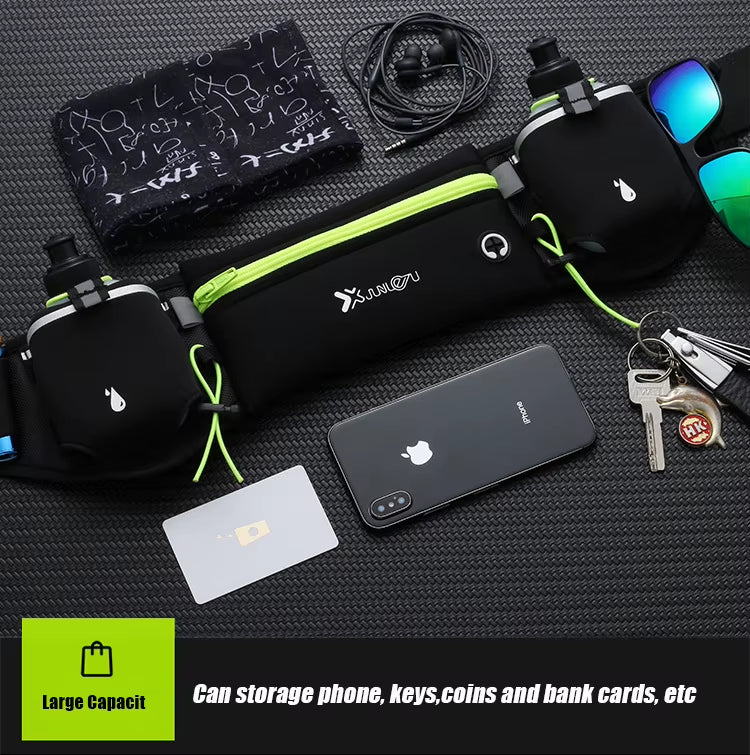 Black waist bag with green accents on a textured surface with phone, keys, and cards displayed.
