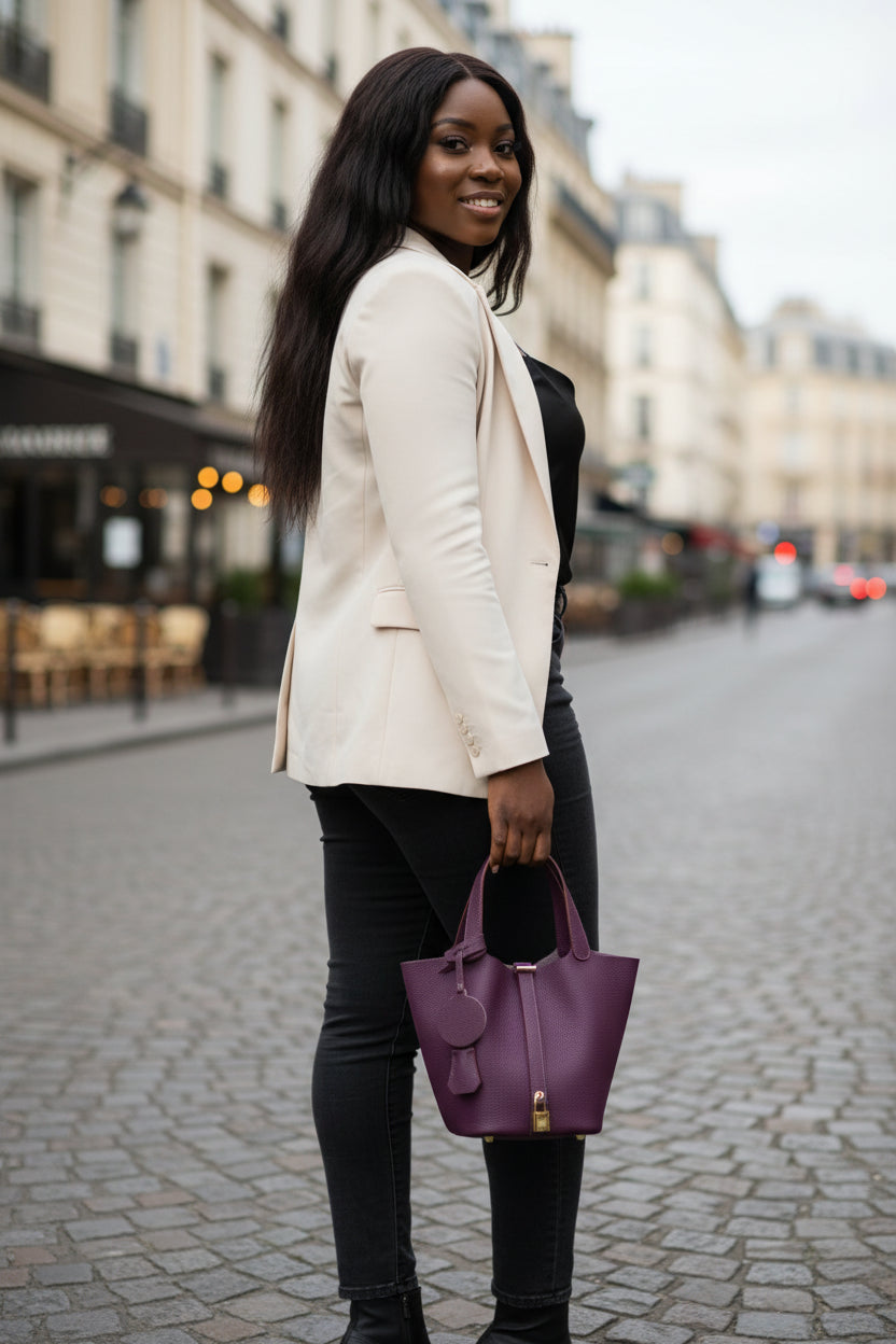 Purple handbag with a gold lock on a light gray background