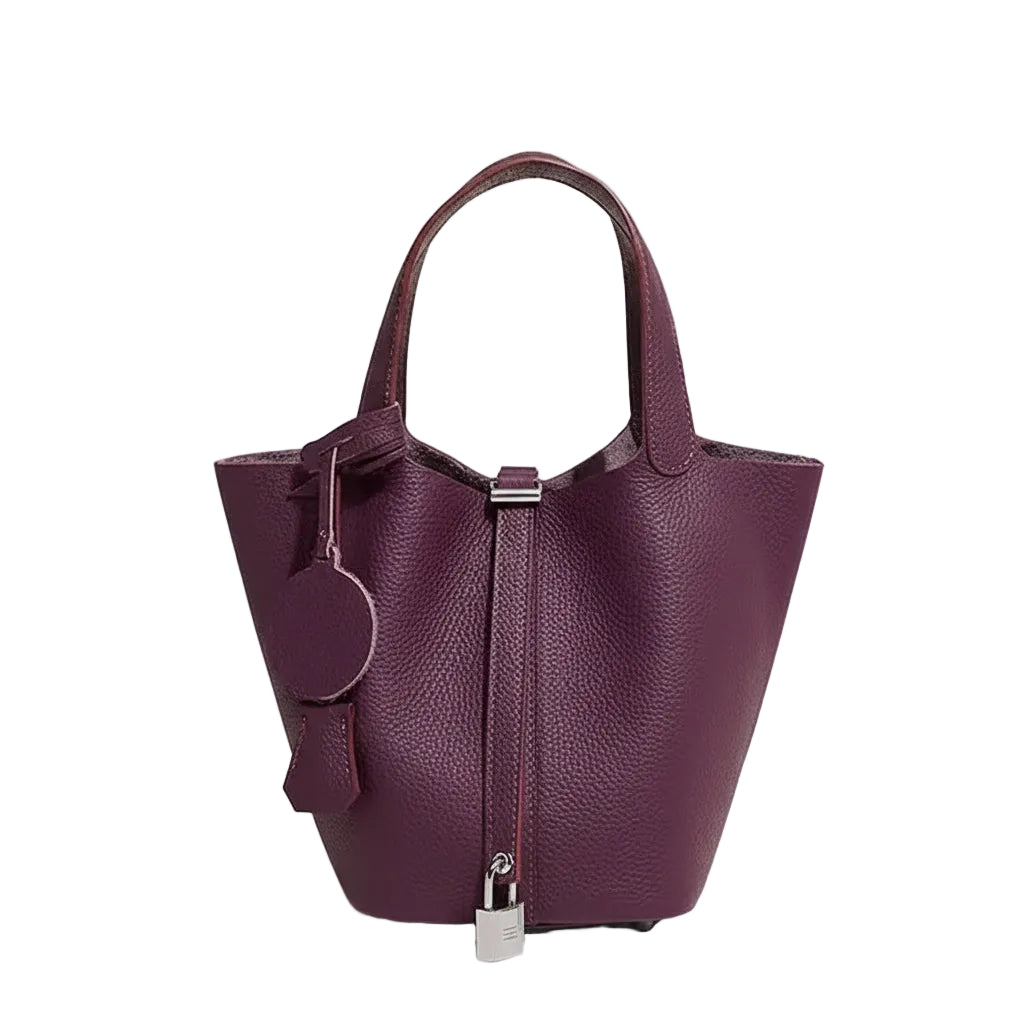 Purple handbag with silver accents on a light gray background