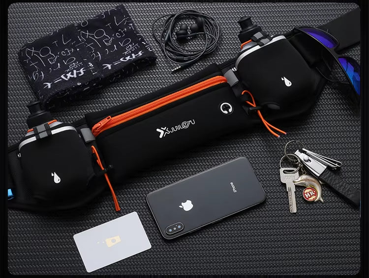 Black waist bag with orange zipper, phone, keys, and cards on a textured surface