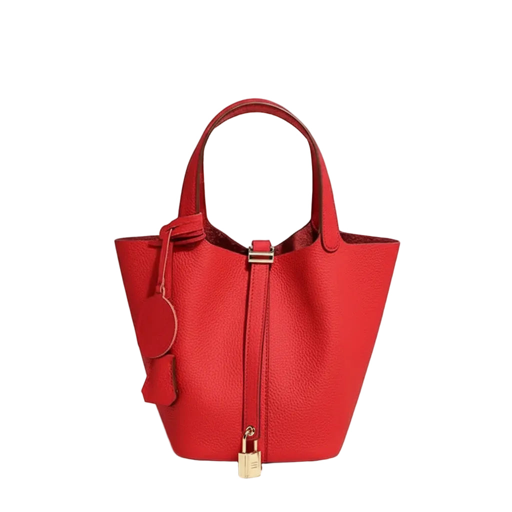 Red handbag with gold accents on a light gray background