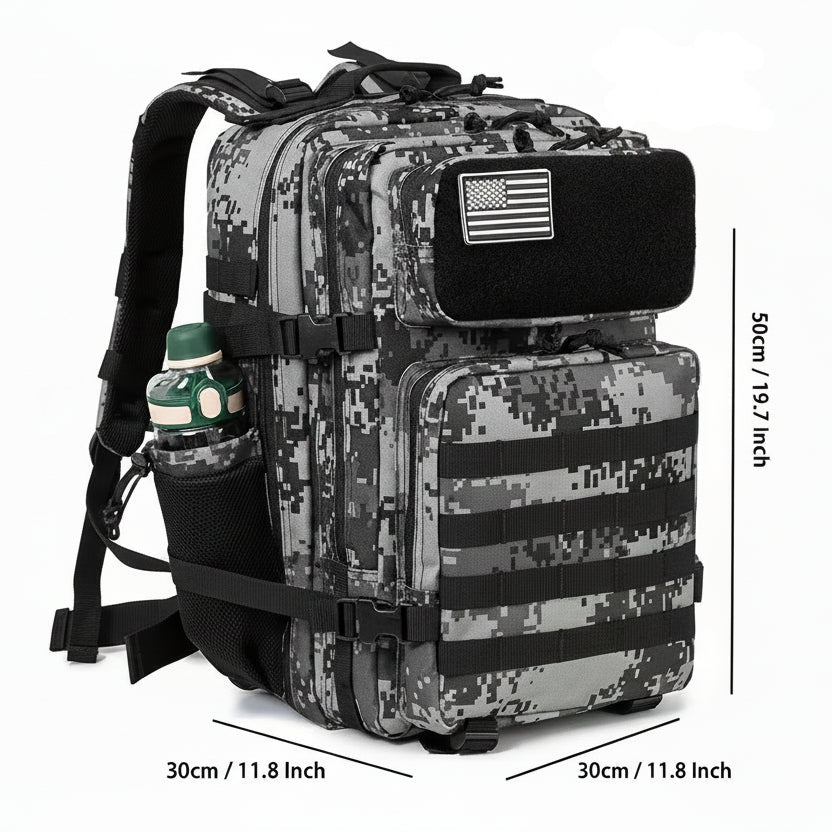 Digital camouflage backpack with American flag patch and water bottle, shown with measurements on a white background.