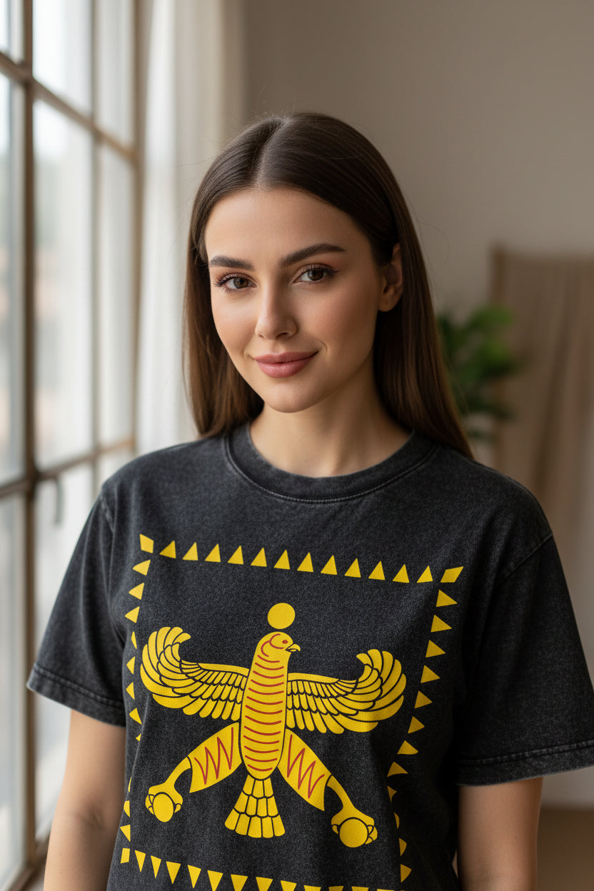 Black t-shirt with yellow winged creature shahbaz design on a white background