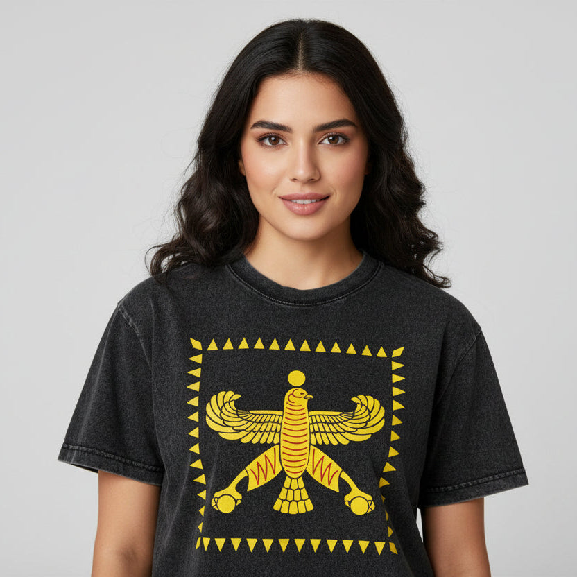 Black t-shirt with yellow winged creature SHAHBAZ design on a white background