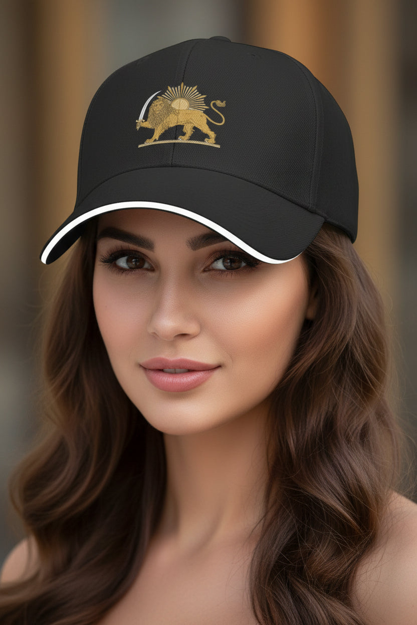 Black cap with a gold lion emblem worn by a model against a blurred background
