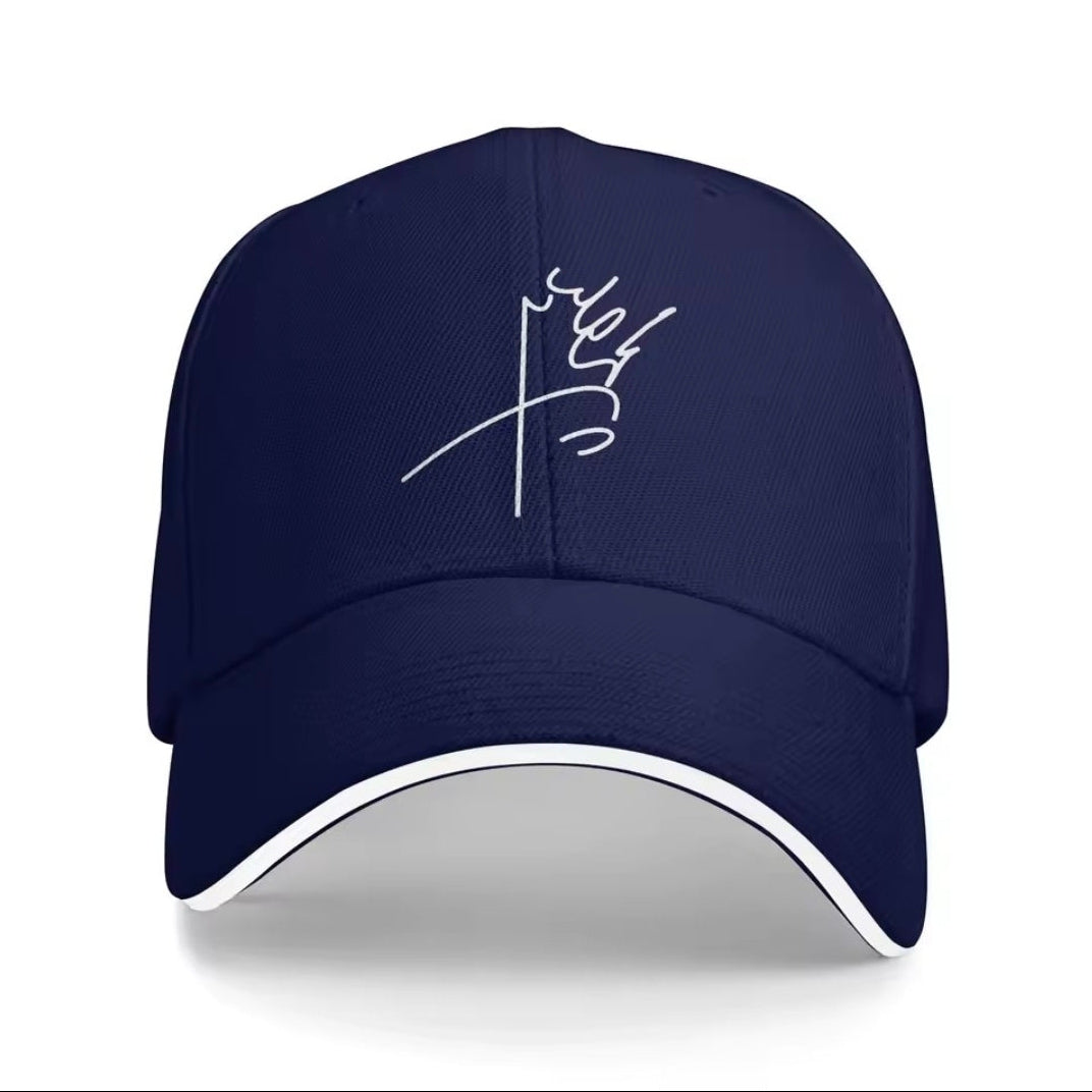 Navy blue cap with white embroidered design on a white background